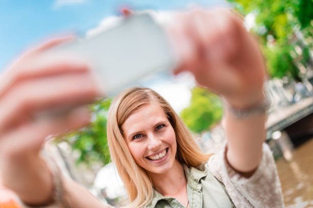 istock tourist take a selfie in amsterdam 686603190