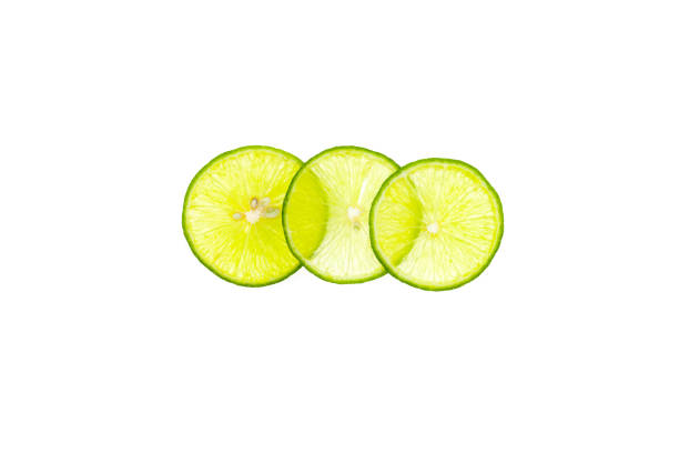 istock Green lemon sliced and stacked isolated on white background. 686608342