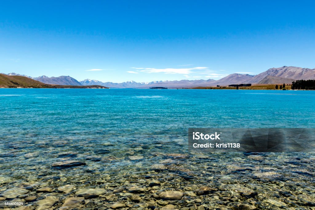 At the shore of Lake Tekapo The Southern Alps behind crystal-clear Lake Tekapo, New Zealand Beauty In Nature Stock Photo