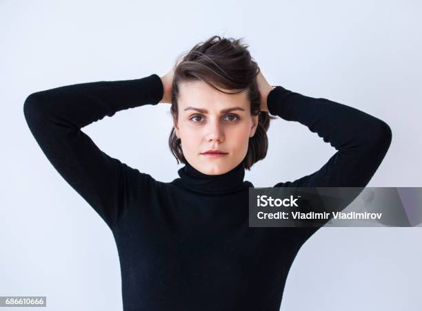 Portrait Of Young Woman With Hands In Hair Stock Photo - Download Image Now - 20-29 Years, Adult, Adults Only
