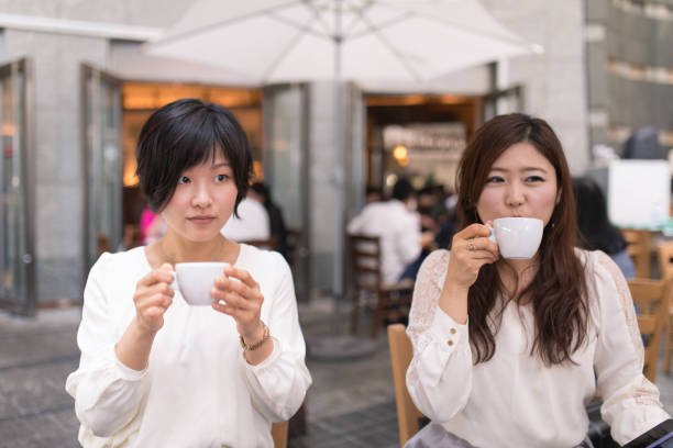 istock Young women drinking coffee after lunch 686611026