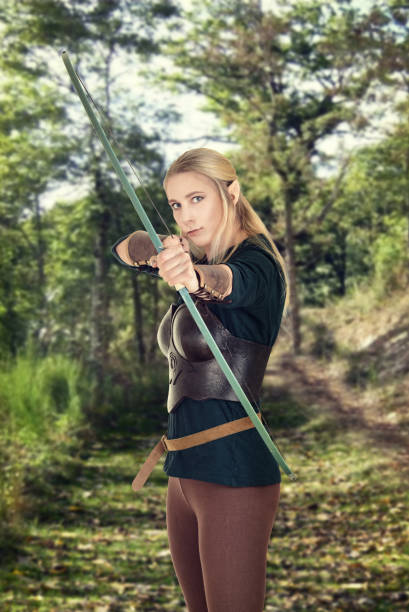 istock female wood elf shooting a bow 686618074