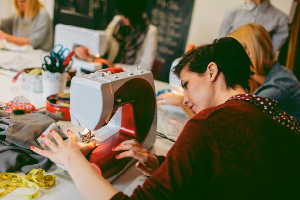classe cucito - manual worker sewing women tailor foto e immagini stock