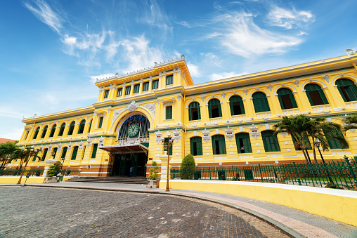 Saigon Central Post Office on blue sky background in Ho Chi Minh, Vietnam. Steel structure of the gothic building was designed by Gustave Eiffel. Ho Chi Minh is a popular tourist destination of Asia.