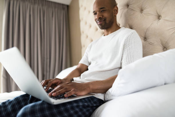istock man working from the bedroom hotel 686623336