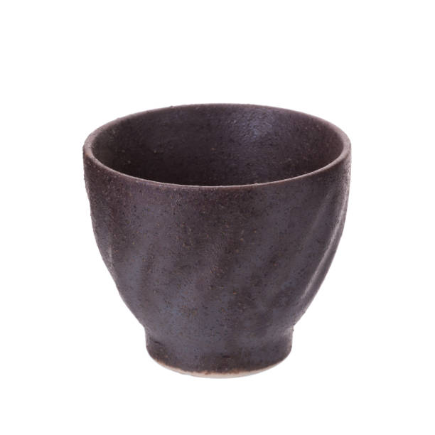 istock Black traditional tea cup of cast iron isolated on white background 686624026