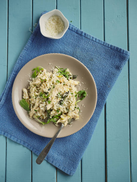Home made chicken asparagus risotto,service with freshness rocket leaves