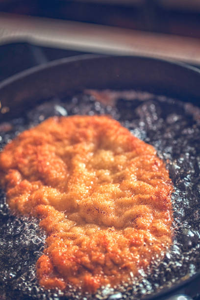 istock Frying Wiener Schnitzel in Deep Oil in a Cooking Pan 686636020