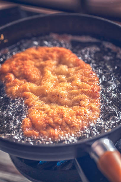 istock Frying Wiener Schnitzel in Deep Oil in a Cooking Pan 686636100