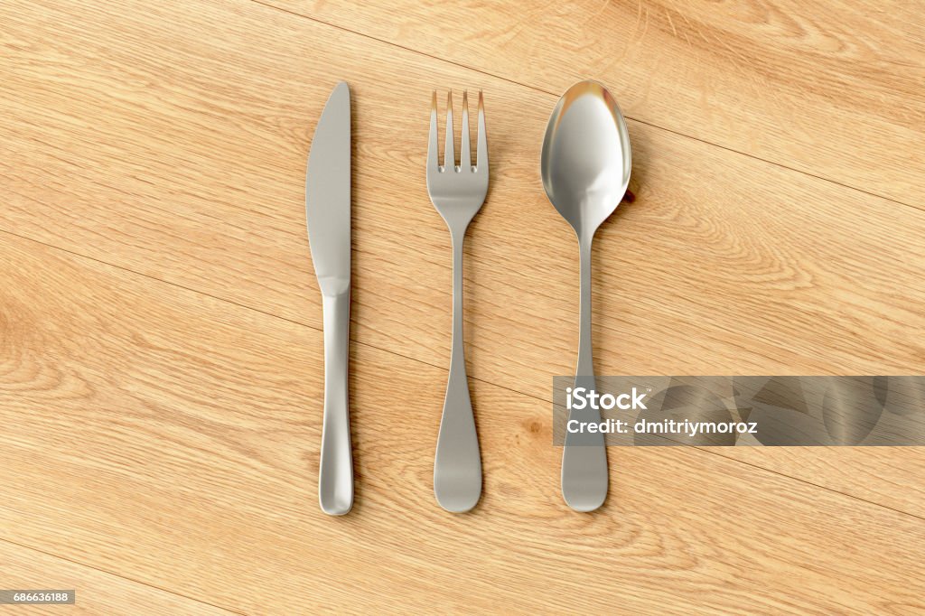 Knife, fork and spoon isolated Knife, fork and spoon isolated on wooden background with clipping path. 3d illustration Arranging Stock Photo