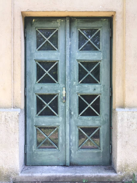 istock old green door with windows an protection grid 686646084