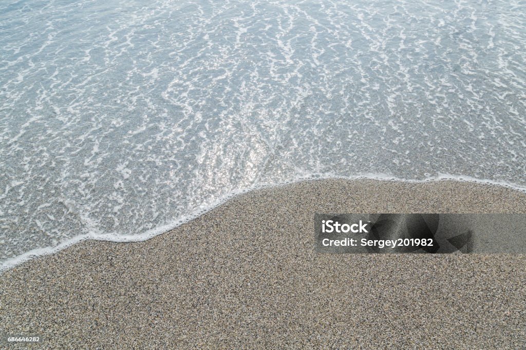 Transparent sea and beach. Pebbles background. Transparent sea and beach. Pebbles beautiful background. Beach Stock Photo