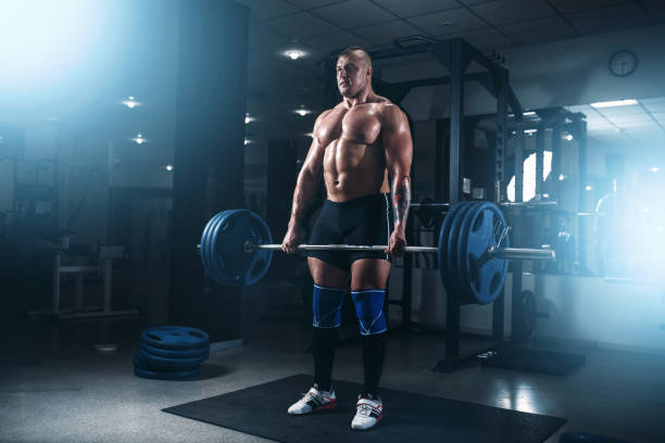 istock Strong athlete exercise with weight in fit gym 686648984