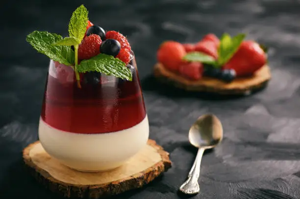 Italian dessert - panna cotta with berries and berry jelly.