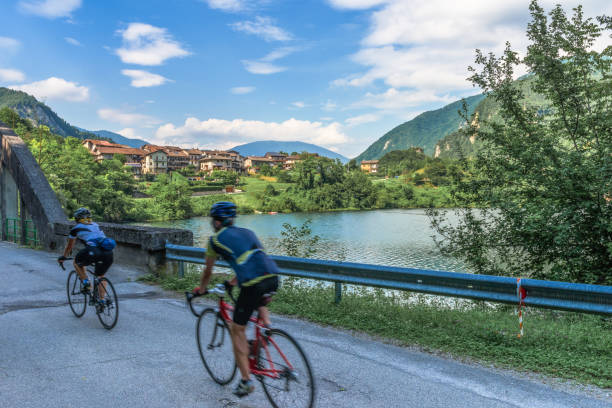 ciclistas en el borde del lago corlo - belluno veneto european alps lake fotografías e imágenes de stock