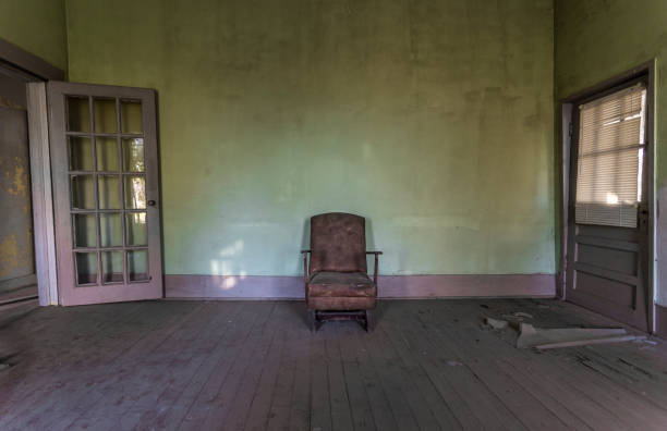 istock Chair against wall in an abandoned house 686663394