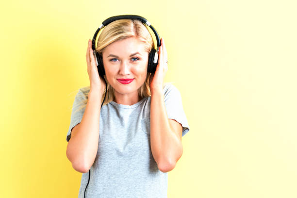 istock Happy young woman with headphones 686664348
