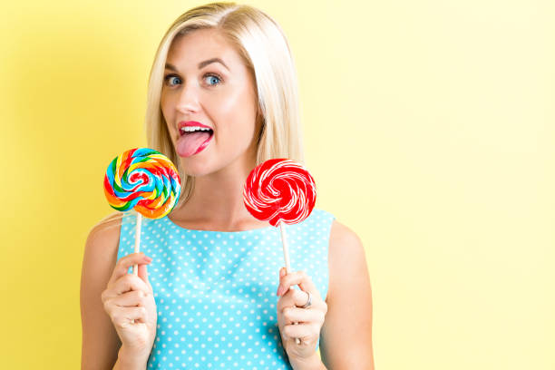 istock Young woman holding lollipops 686666596