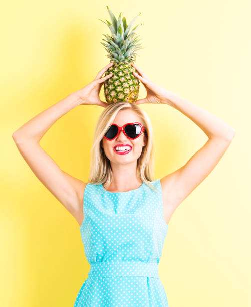 istock Happy young woman holding a pineapple 686666640