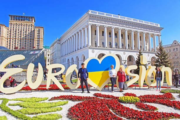 Unidentified tourists near part of official logo of Eurovision Song Contest 2017 on Maidan Nezalezhnosti (Independence Square) stock photo