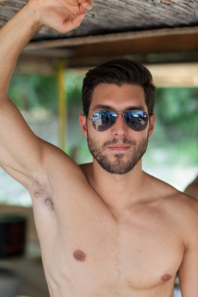 istock young sexy man on a beach,shallow depth of field 686677906