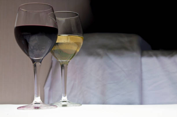 istock Two glasses of wine next to bed. Romantic evening. 686678682