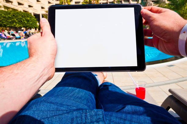 istock Man with tablet next to a hotel pool. Point of view 686681210