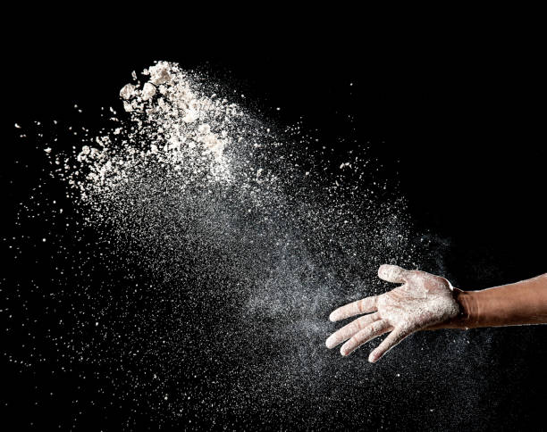 istock Hand and flour on black background 686689790