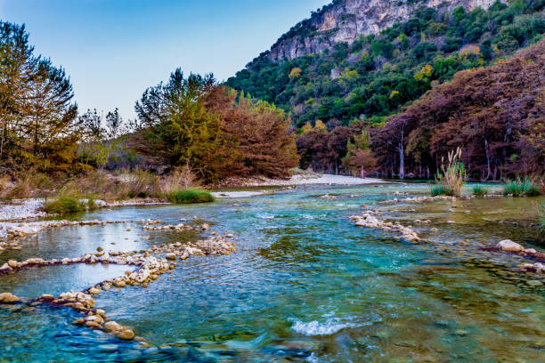 istock Fall foliage on the crystal clear Frio River in Texas. 686690280