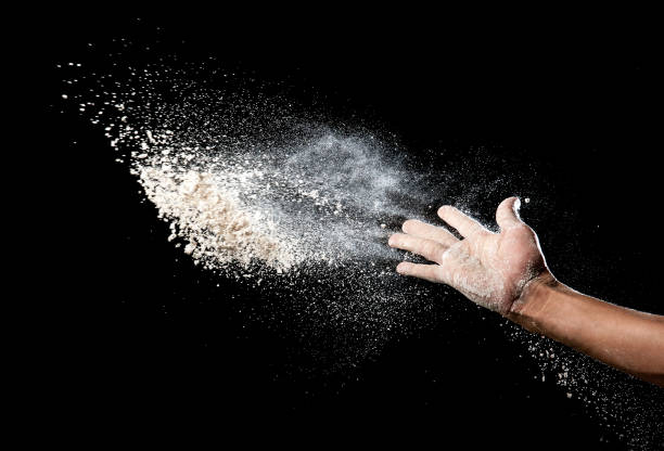 istock Hand and flour on black background 686692666