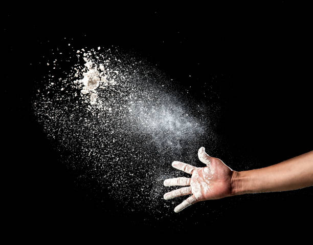 istock Hand and flour on black background 686696760