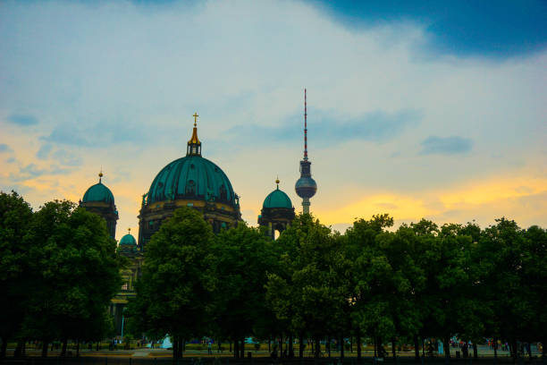 berliner dom and fernsehturm against an cloudy evening sky, berlin, germany 13/06/2015 - museum monument silhouette tree imagens e fotografias de stock