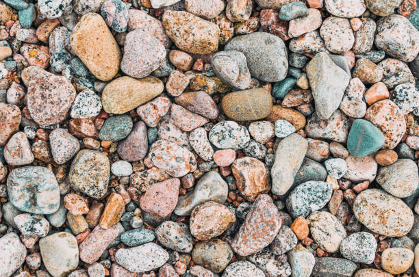 istock Background texture of round granite beach stones. 686702570