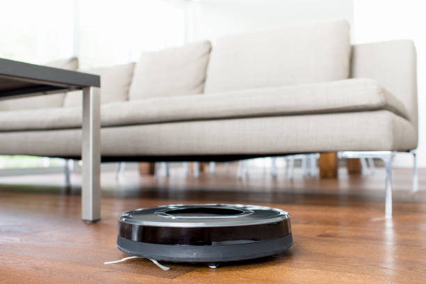 istock Robotic Vacuum Cleaner in Living Room 686702710