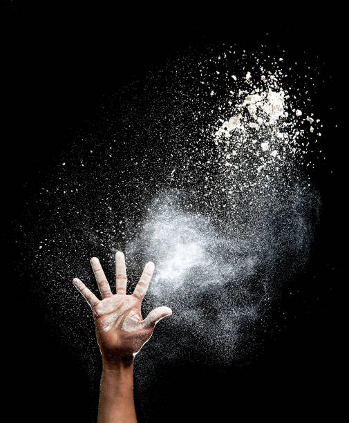 istock Hand and flour on black background 686706132