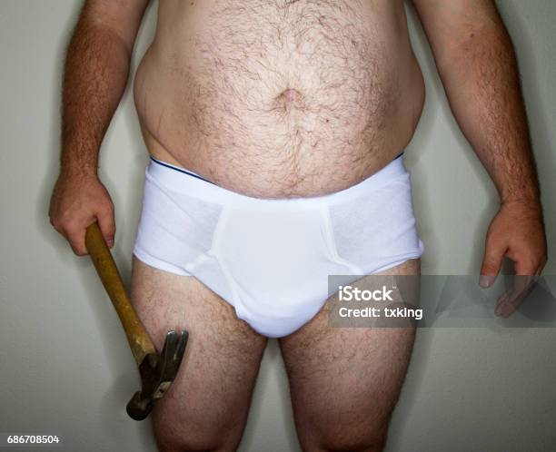 Man Holding A Hammer In His Undies Stock Photo - Download Image Now - Construction Worker, Overweight, Sweat