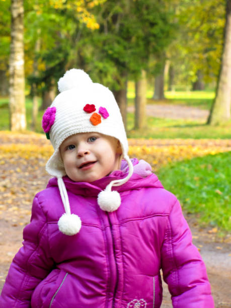 istock smiling girl in a white hat 686709308
