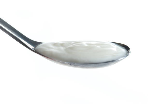 istock Spoon of milk cream isolated on white background 686711868