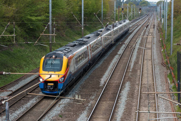 Fast British passenger train in motion St Albans: British East Midlands train in motion on the railway midlands england stock pictures, royalty-free photos & images