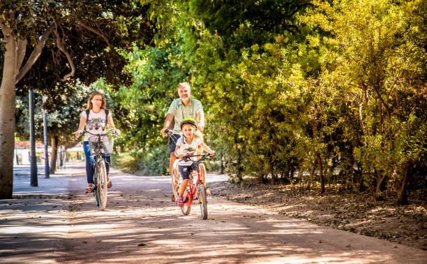 istock Father With Two Daughters Riding Bike In Valencia 686712494
