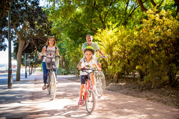 istock Father With Two Daughters Riding Bike In Valencia 686712496