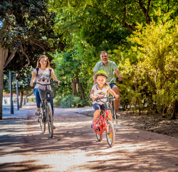 istock Father With Two Daughters Riding Bike In Valencia 686712502