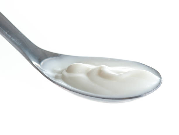 istock Spoon of milk cream isolated on white background 686717518