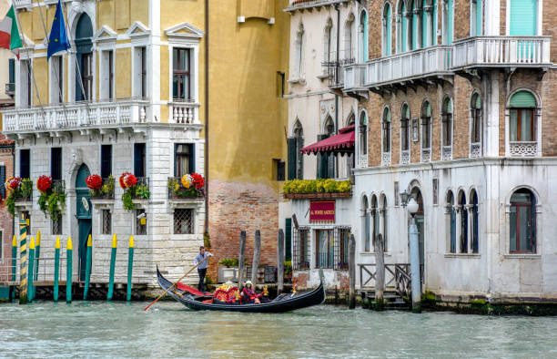 Hotel Al Ponte Antico, on Grand Canal, Venice, Italy VENICE, ITALY - MAY 03, 2016 : View of the Hotel Al Ponte Antico, Grand Canal, Venice, with gondolas and tourists. palazzo antico stock pictures, royalty-free photos & images