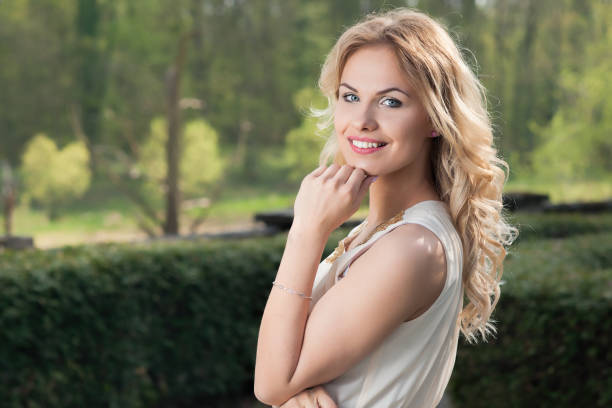 istock Elegant young female on green natural background 686724134