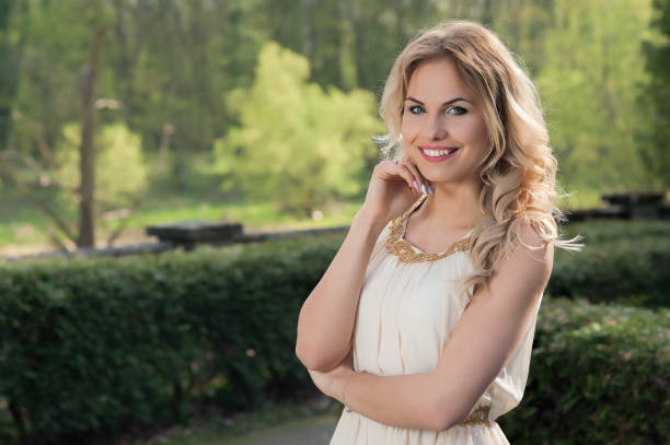 istock Elegant young female on green natural background 686724194
