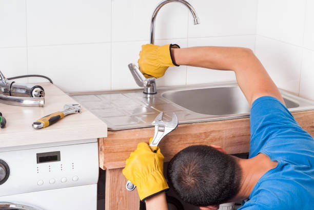 istock plumber installs the faucet 686724326