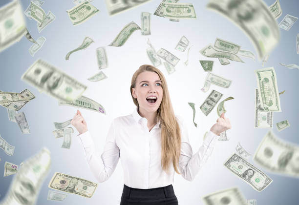 istock Happy woman under a dollar rain 686727704