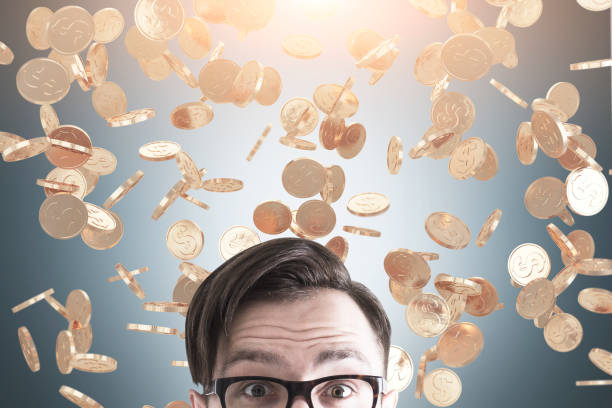 istock Man s head and coin rain 686727826