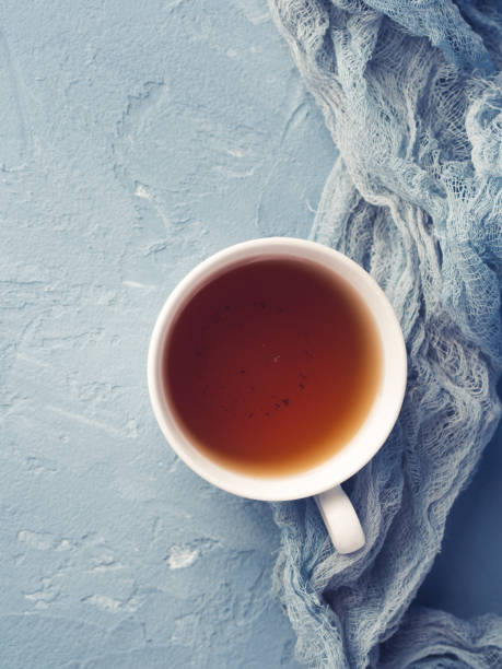 istock Cup of tea on blue background with flowers 686730514